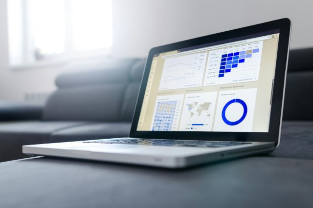 Digital-Marketing Sleek laptop showcasing data analytics and graphs on the screen in a bright room.